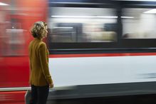 Businesswoman looking at train passing by