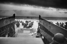 A LCVP (Landing Craft, Vehicle, Personnel) from the U.S. Coast Guard-manned USS Samuel Chase disembarks troops of Company E, 16th Infantry, 1st Infantry Division (the Big Red One) wading onto the Fox Green section of Omaha Beach (Calvados, Basse-Normandie, France) on the morning of June 6, 1944. American soldiers encountered the newly formed German 352nd Division when landing. During the initial landing two-thirds of Company E became casualties.