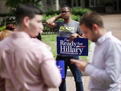 Young man holding a sign that reads "I'm Ready for Hillary"