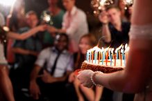 Person carrying a birthday cake