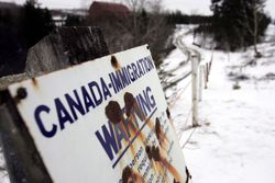 Sign along US – Canada border warns of Canadian immigration laws