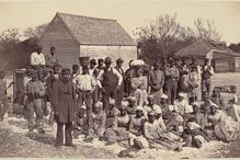 Photograph of American slaves on a farm.