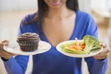 woman choosing vegetables or cupcake
