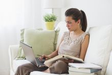 USA, New Jersey, Jersey City, Young woman working from home, using laptop