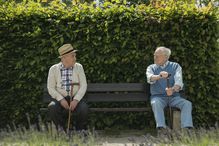 Germany, Two old friends sitting on bench in park