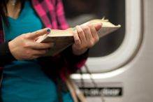 Reading book on subway