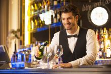 Barman pouring drinks during aperitivo