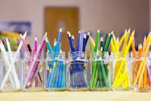 Containers of pencils organized by color