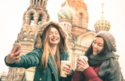 Happy girlfriends taking winter selfie in Saint Petersburg Russia