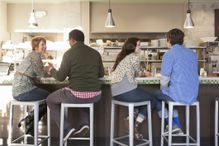 Group of customers socializing at diner counter