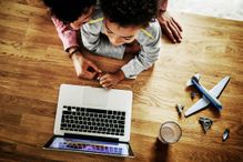 child and parent on laptop