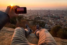 Man taking pictures of a Barcelona sunrise.