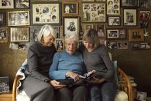 Three Generations of Women Looking at Photo Album