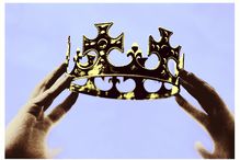 Hands holding up a crown