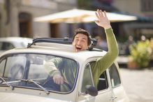 Italian man waving from Fiat