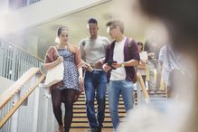 College students talking and descending stairway