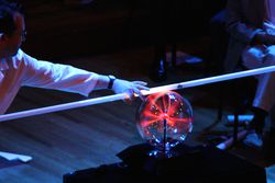 man using fluorescent light with a plasma ball