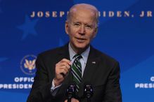 Joe Biden speaking behind a microphone