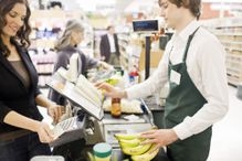 Cashier scanning bananas in grocery store