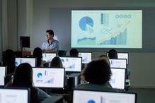 Teacher giving a lecture at the IT classroom