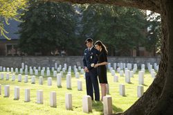 Soldier and wife visiting cemetery together