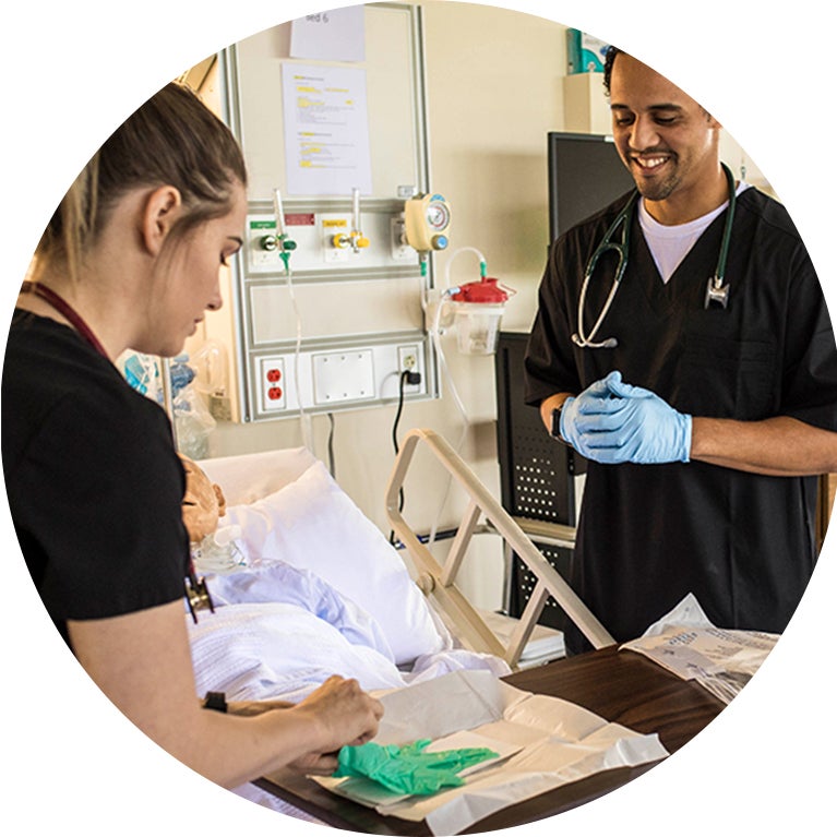 Nursing students helping patient