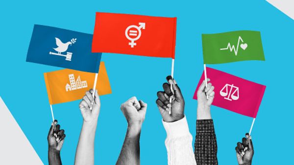 Photocomposition: five hands holding small flags with the sustainable development goals 11, 3, 5, 2 and 4 icons