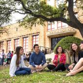 Social work students outside on lawn in front of school building.