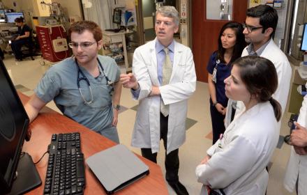 Dean Clay Johnston talks with hospital staff.