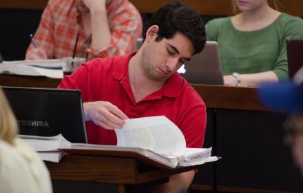 Law student looks through notes while in class.