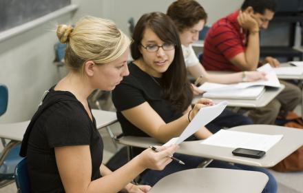 Students in class discussing notes.