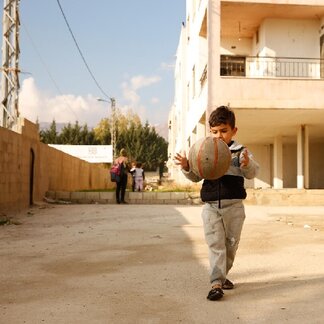 Boy playing with a ball. Photo credit: Gabrielle Menezes