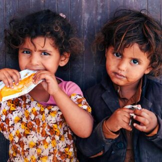 Two children eating nutritional snack