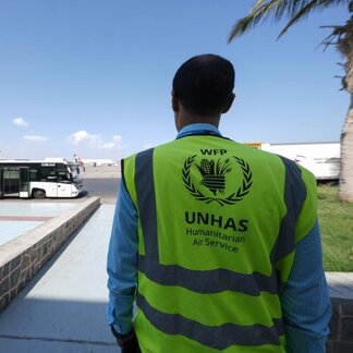 UNHAS worker standing at side of airport 