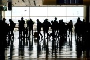 Travelers walk through the Salt Lake City International Airport in Salt Lake City, March 17, 2021 (AP photo by Rick Bowmer).